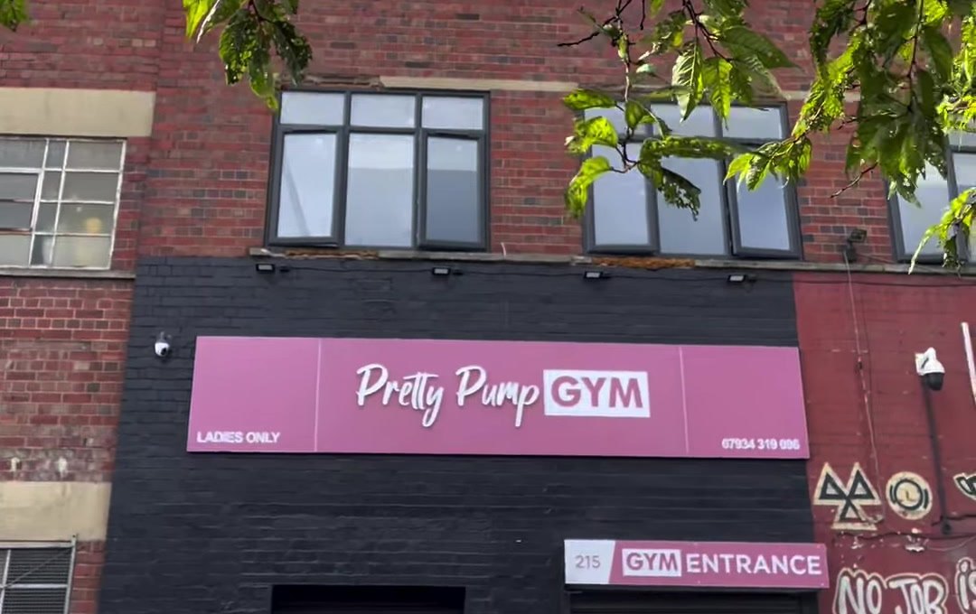 The brick building on Adderley Road with the mauve Pretty Pump Gym, Ladies Only shop sign